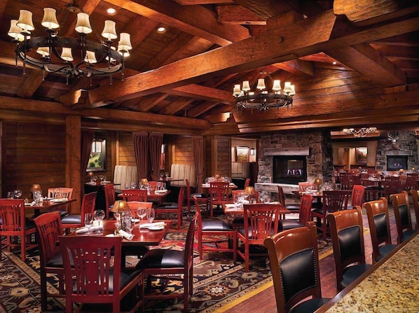 A spacious dining area with wooden beams, chandeliers, and red upholstered chairs. - Ameristar Casino Resort Spa Black Hawk (Black Hawk)