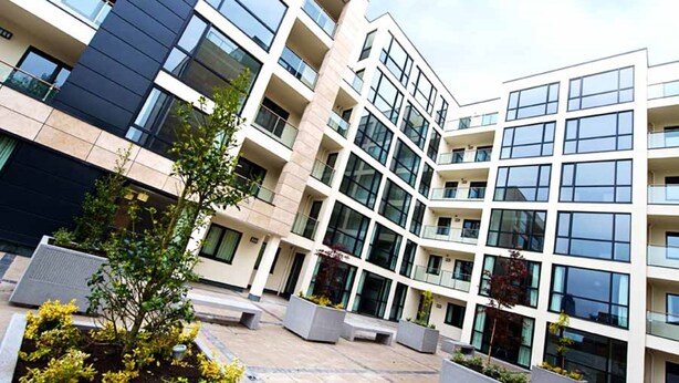 A modern multi-story building with a courtyard featuring planters and seating areas. - Staycity Aparthotels, Liverpool, City Centre (Liverpool)