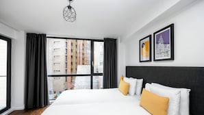 A modern hotel room with a large bed, black curtains, and two framed artworks on the wall. - Staycity Aparthotels, Liverpool, City Centre (Liverpool)