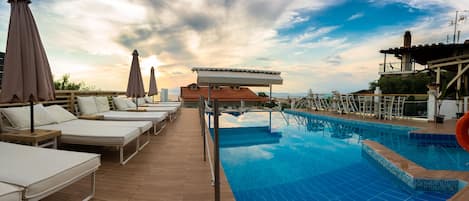 Seasonal outdoor pool, open 10:00 AM to 7:30 PM, pool umbrellas