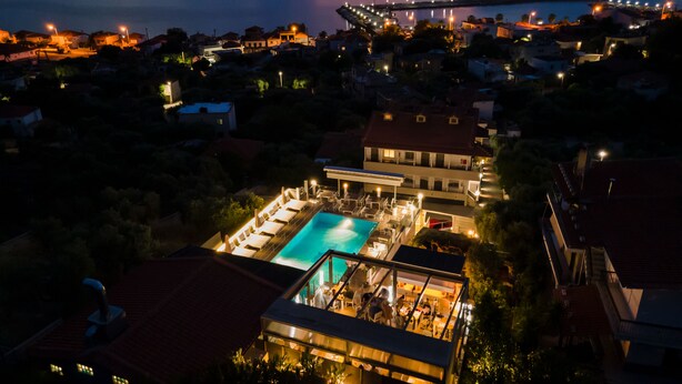 A resort with a swimming pool, multiple buildings, and a view of the sea. - Anny Residences & Suites (Thasos)