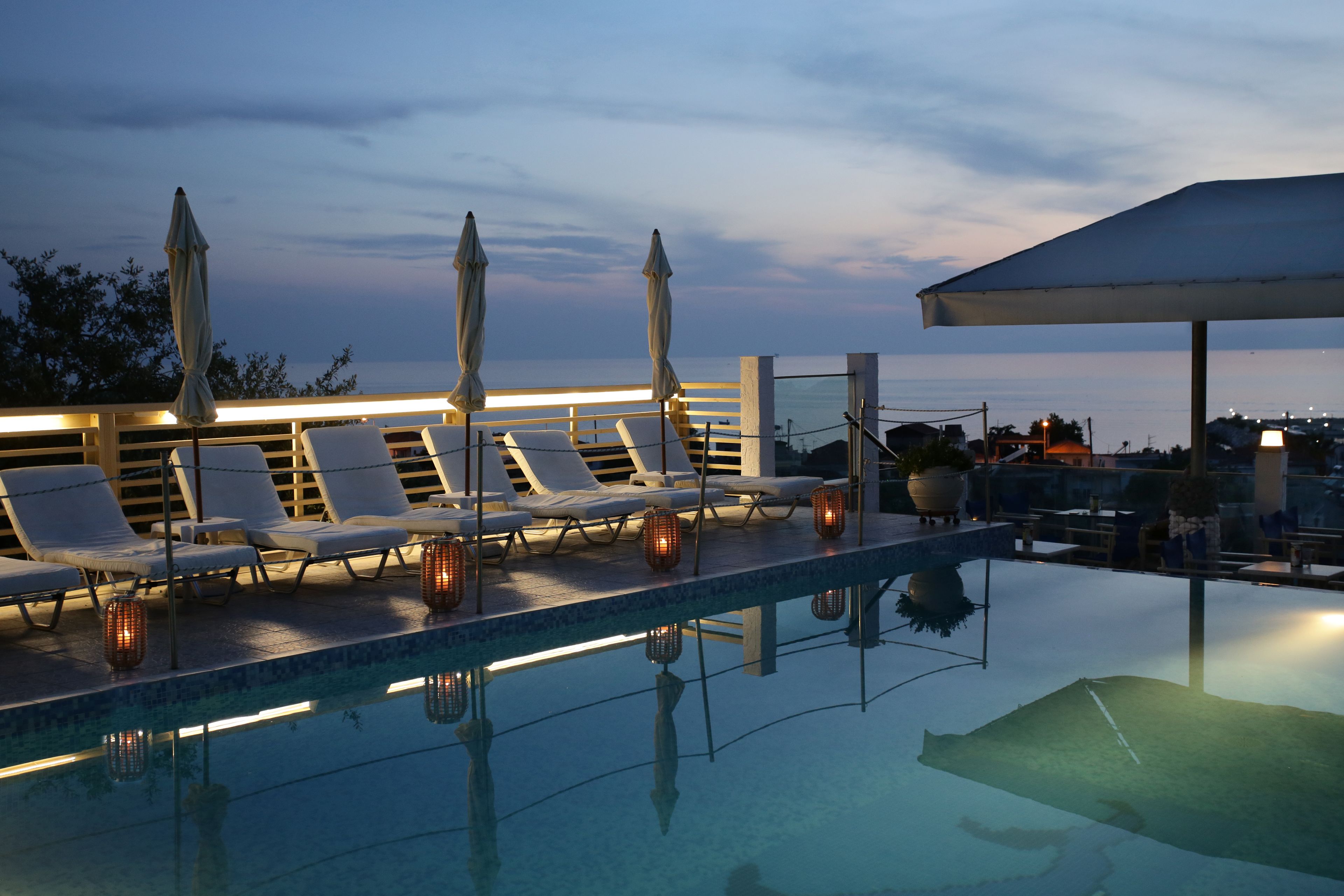 Seasonal outdoor pool, open 10:00 AM to 7:30 PM, pool umbrellas