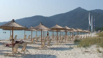 On the beach, sun-loungers, beach umbrellas, beach towels