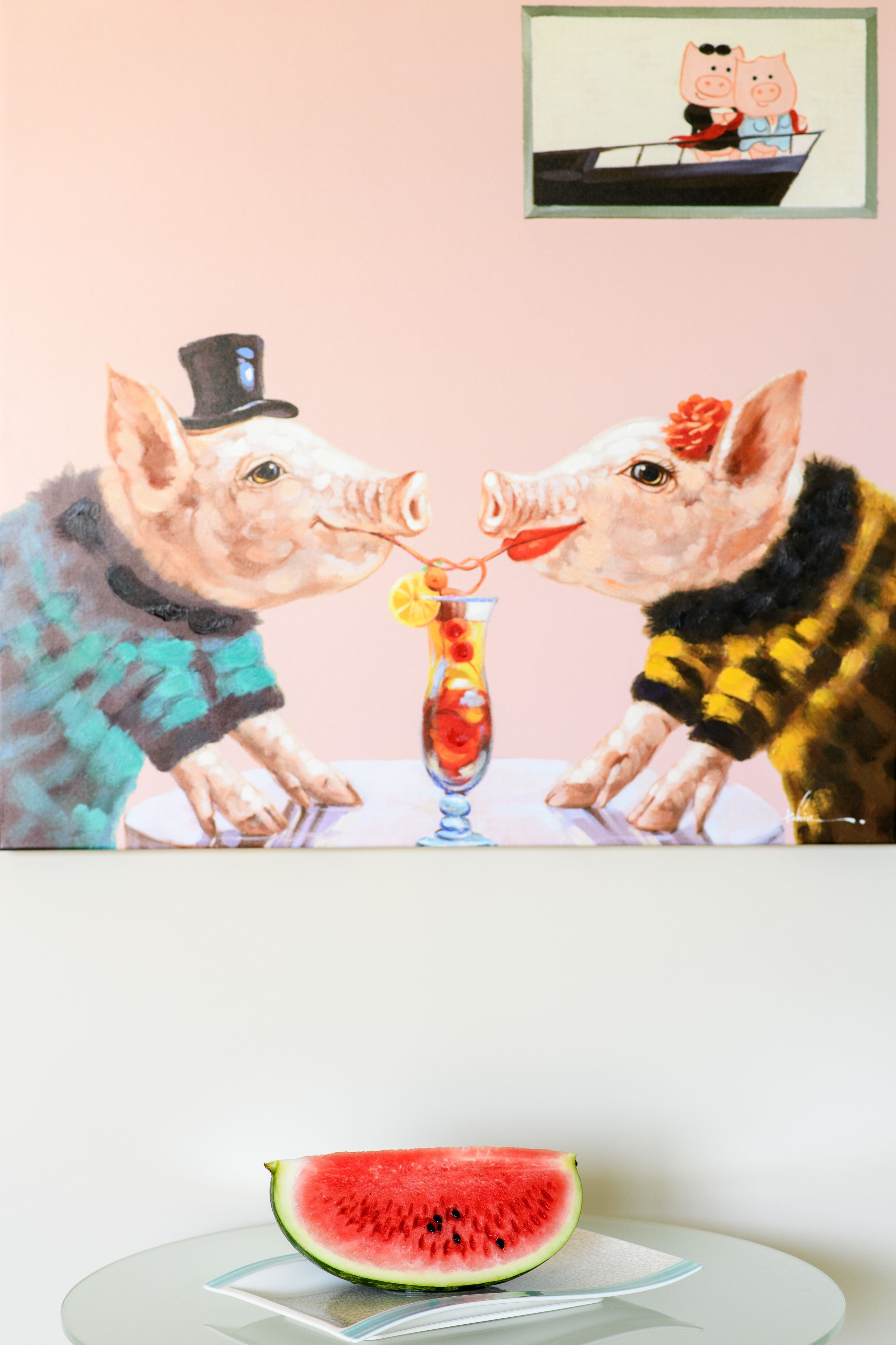 A painting of two pigs at a table with a glass of fruit drink.