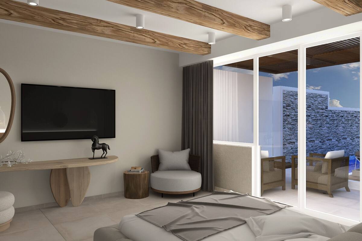Een moderne woonkamer met een grote flatscreen televisie, een ronde spiegel, een klein beeldje en uitzicht op een stenen muur en de lucht door grote ramen.