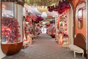 A corridor with floral arrangements, chandeliers, and ornate furniture. - Country Inn & Suites by Radisson, Sahibabad, Distt Ghaziabad (U.P.) (Ghaziabad)