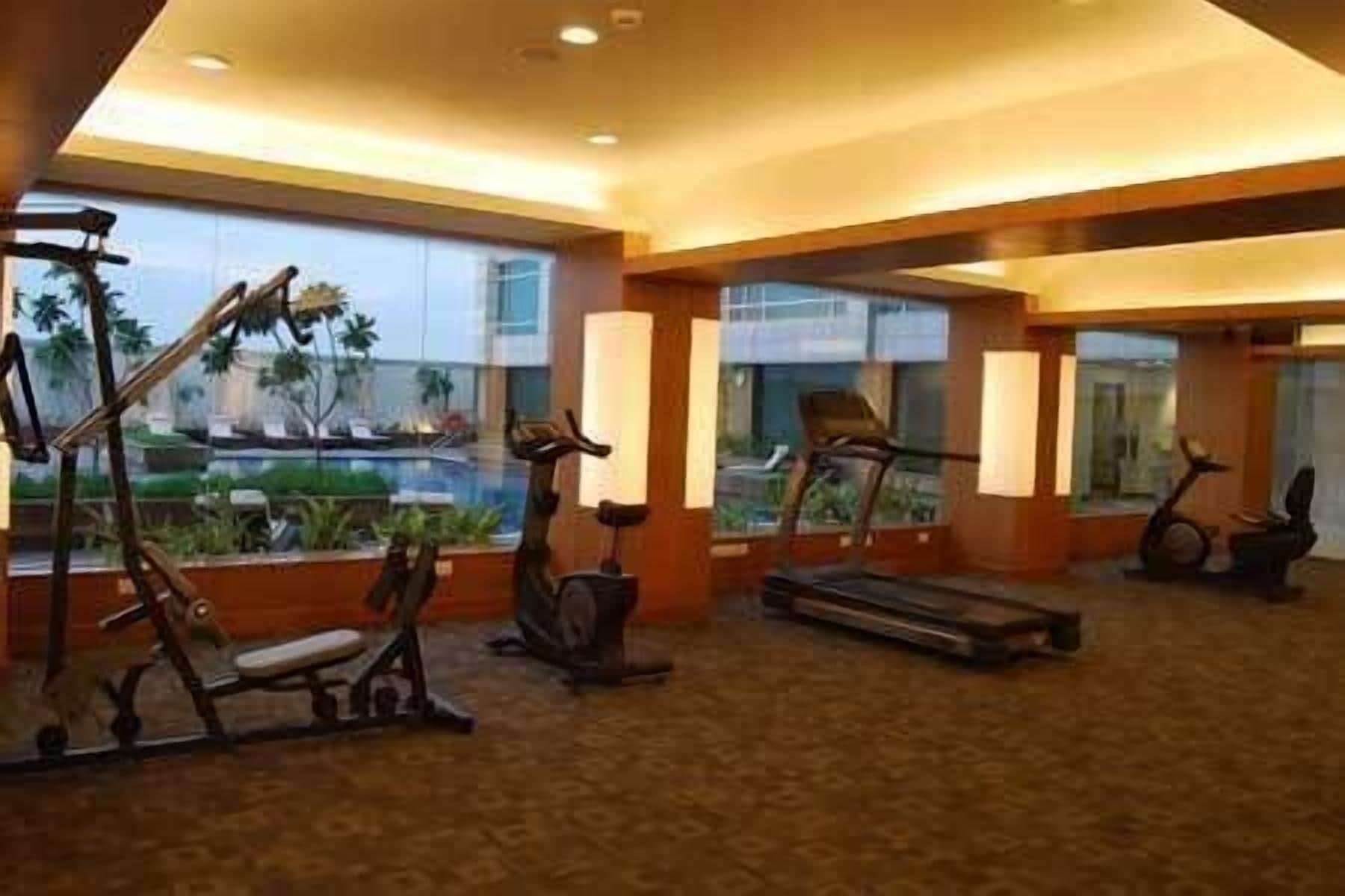 A gym with stationary bikes, treadmills, and a rowing machine.