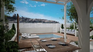 A poolside area with a wooden deck, a pool, and a seating area with white lounge chairs. - Kedros Villas (Naxos)