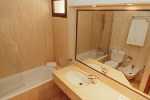 A modern bathroom with a bathtub, a sink, a bidet, and a toilet. - LIVVO Lago Taurito Hotel & Aquapark All Inclusive (Mogan)