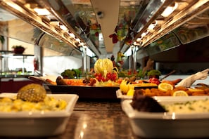 Indulge in a sumptuous spread of fresh fruits, vegetables, and prepared dishes at our buffet.