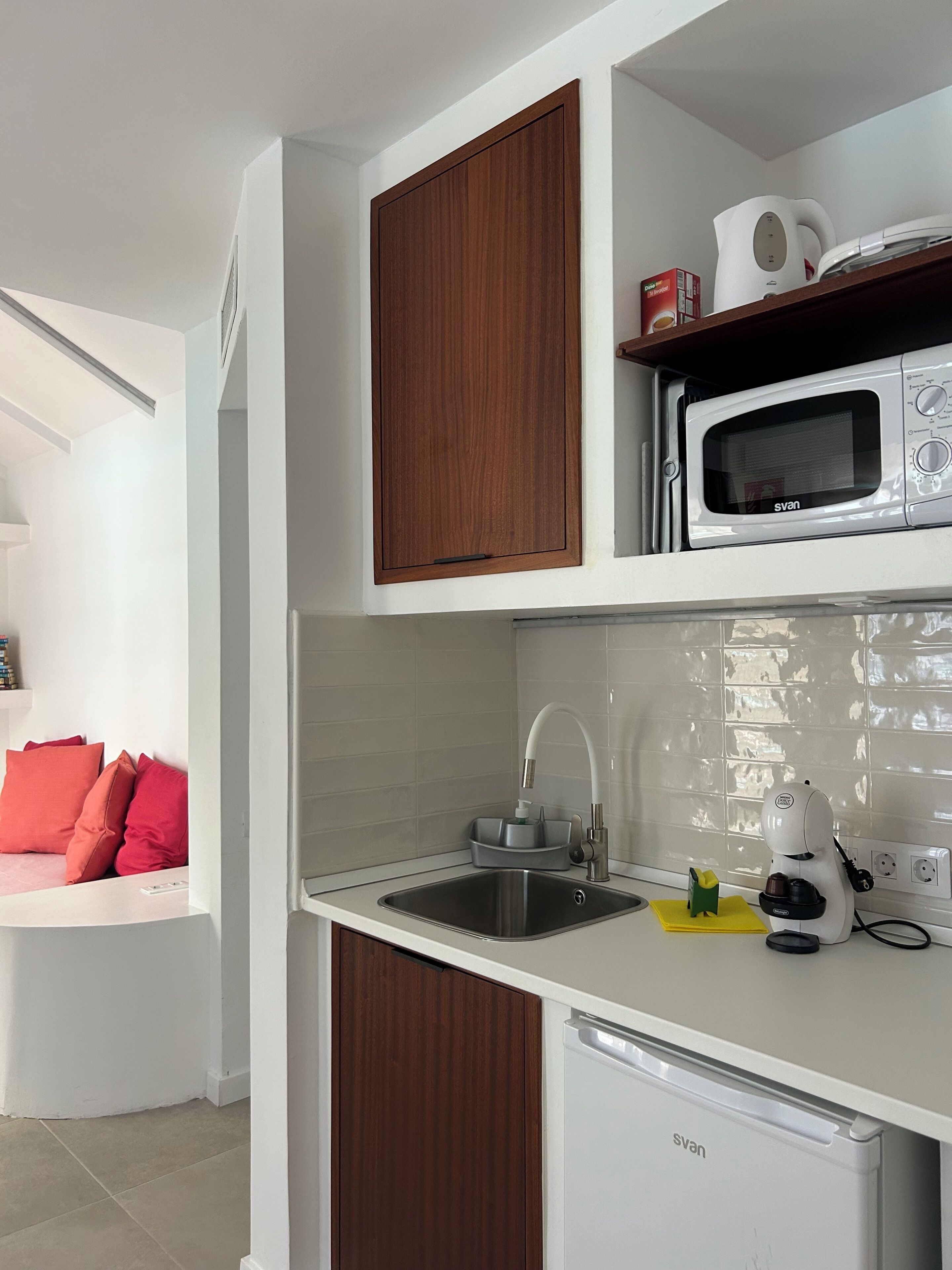 A modern kitchen with a built-in microwave, a sink, and a dishwasher.