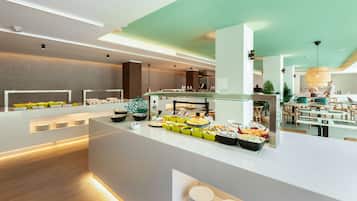 Un área de buffet moderna con diversas opciones de comida, un espacio de estar con mesas y sillas, y un diseño limpio y contemporáneo.