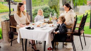 A dining table set with plates, glasses, and cutlery.