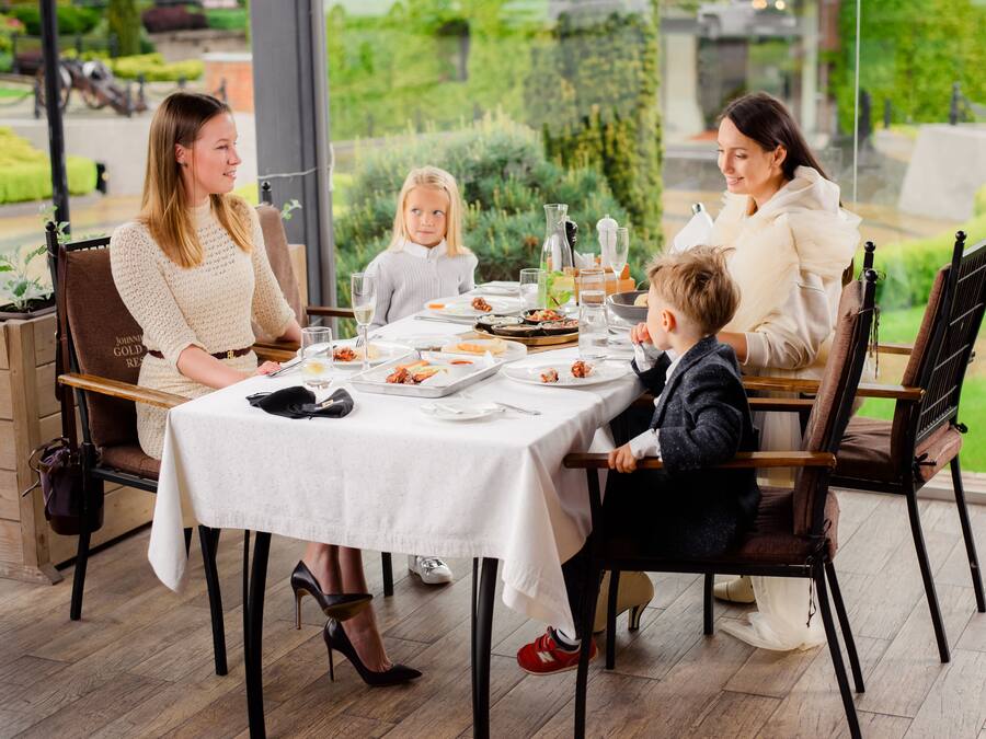 A dining table set with plates, glasses, and cutlery.