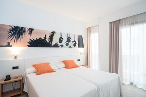A hotel room with two beds, a nightstand, a painting on the wall, and a window with curtains. - Hotel THB Ocean Beach - Adults Only (Sant Antoni de Portmany)