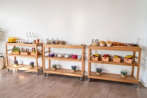 Three wooden mobile carts with wheels, each stocked with various items like bottles, plates, and baskets. - Hotel THB Ocean Beach - Adults Only (Sant Antoni de Portmany)