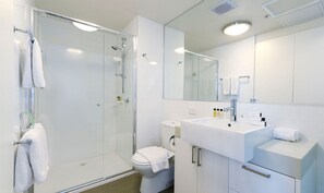 Shower, designer toiletries, hair dryer, towels