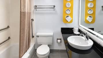 A modern bathroom with a bathtub, toilet, and sink.