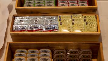 Three wooden boxes containing various packaged food items.