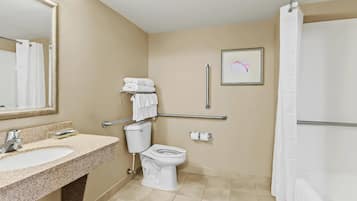 A bathroom with a sink, toilet, and shower.