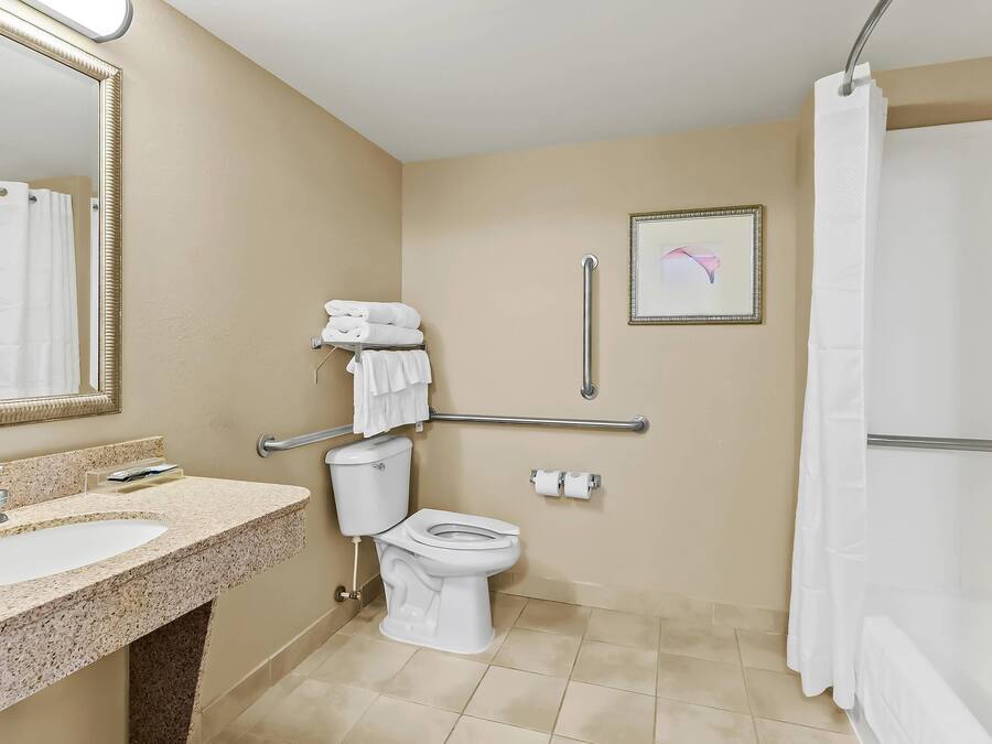 A bathroom with a sink, toilet, and shower.