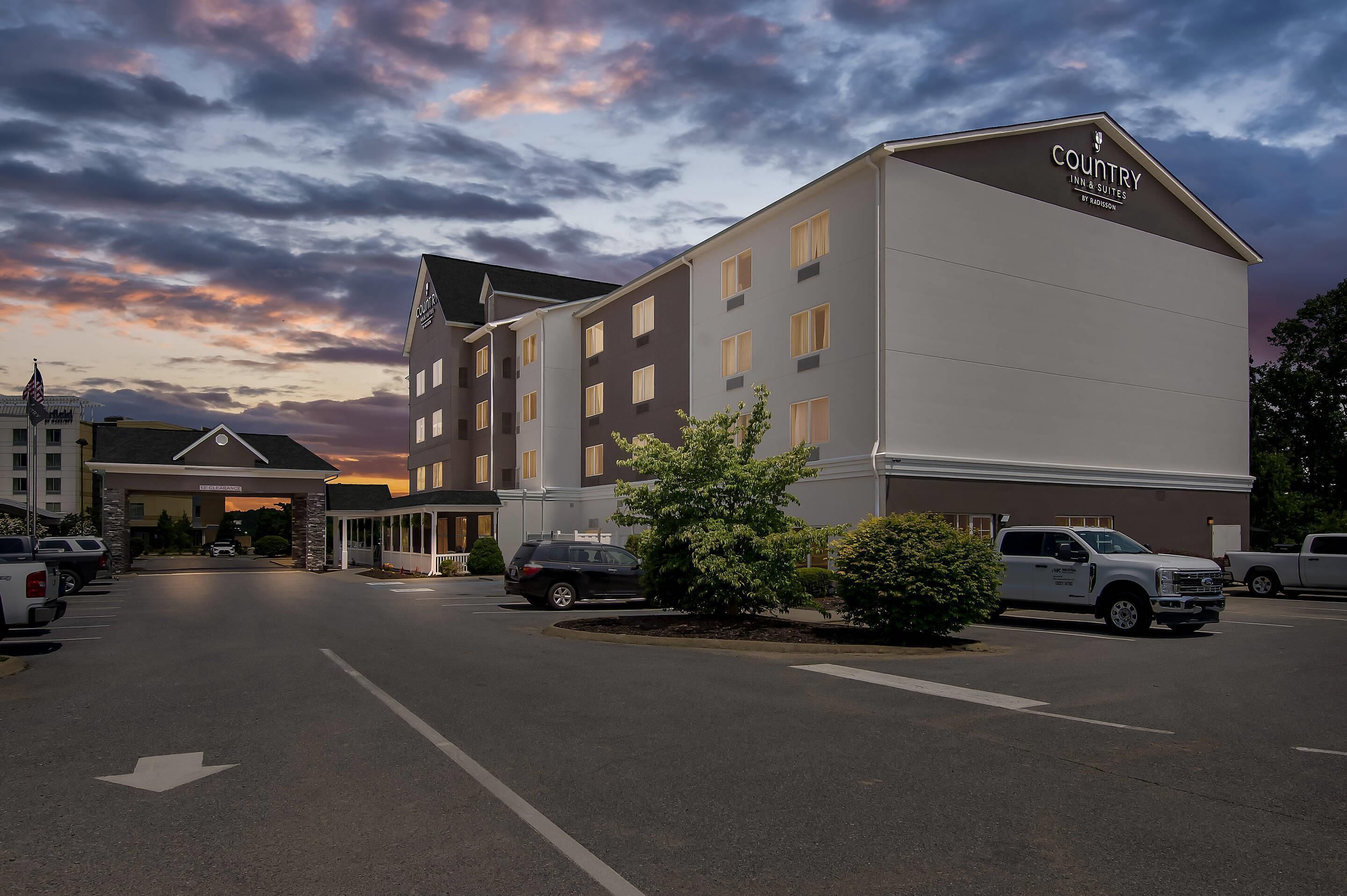 Et Country Inn & Suites by Wyndham med parkeringsplads og bygningens indgang.