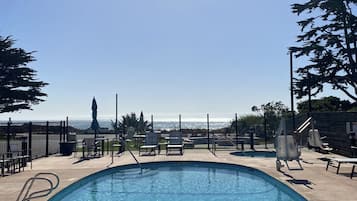 Outdoor pool, open 9:00 AM to 9:00 PM, pool umbrellas