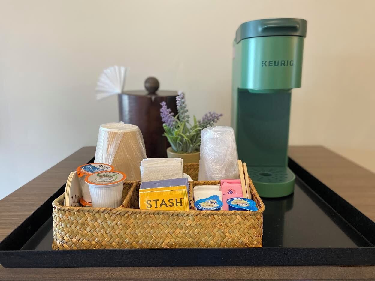 A tray with various food items and a Keurig coffee maker.
