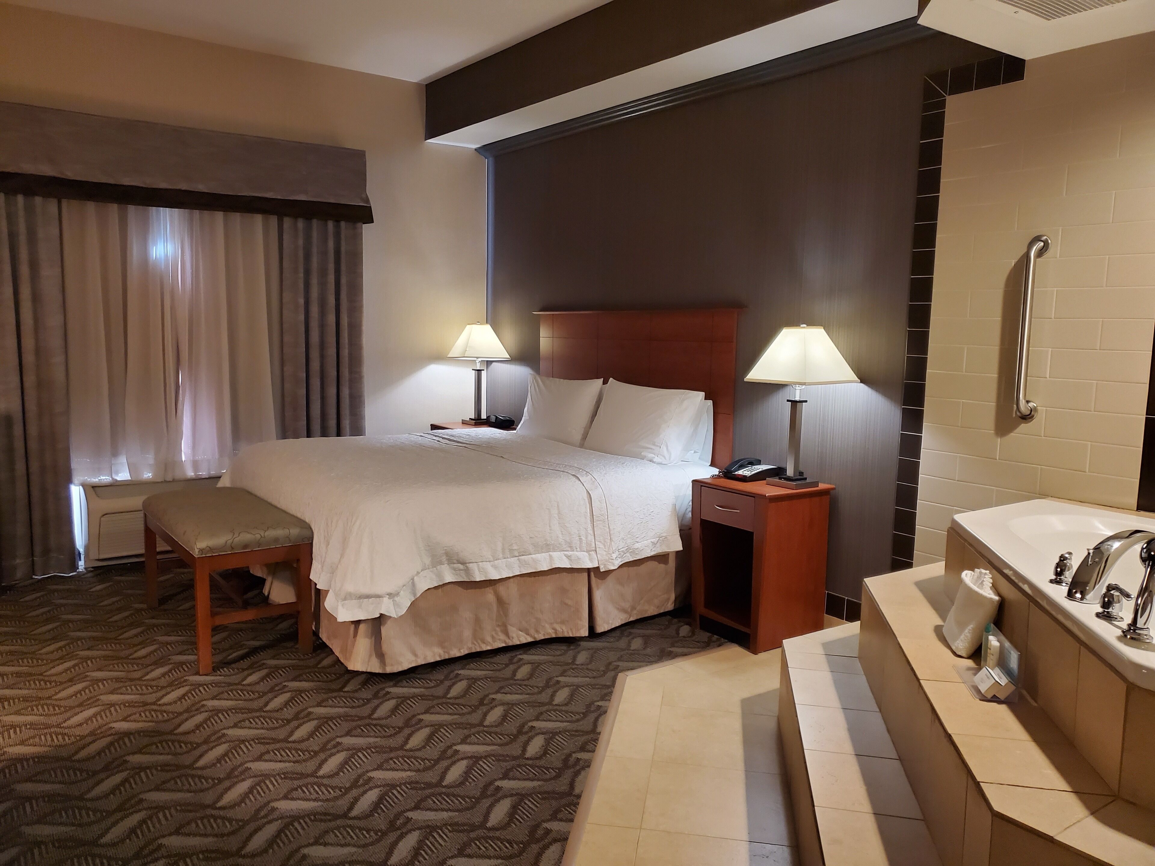 suite, 1 king bed, non smoking, jetted tub | in-room safe, iron/ironing board, free wifi, alarm clocks