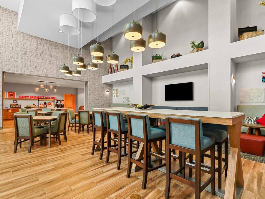 A modern interior with a bar area, seating, and a kitchen counter.