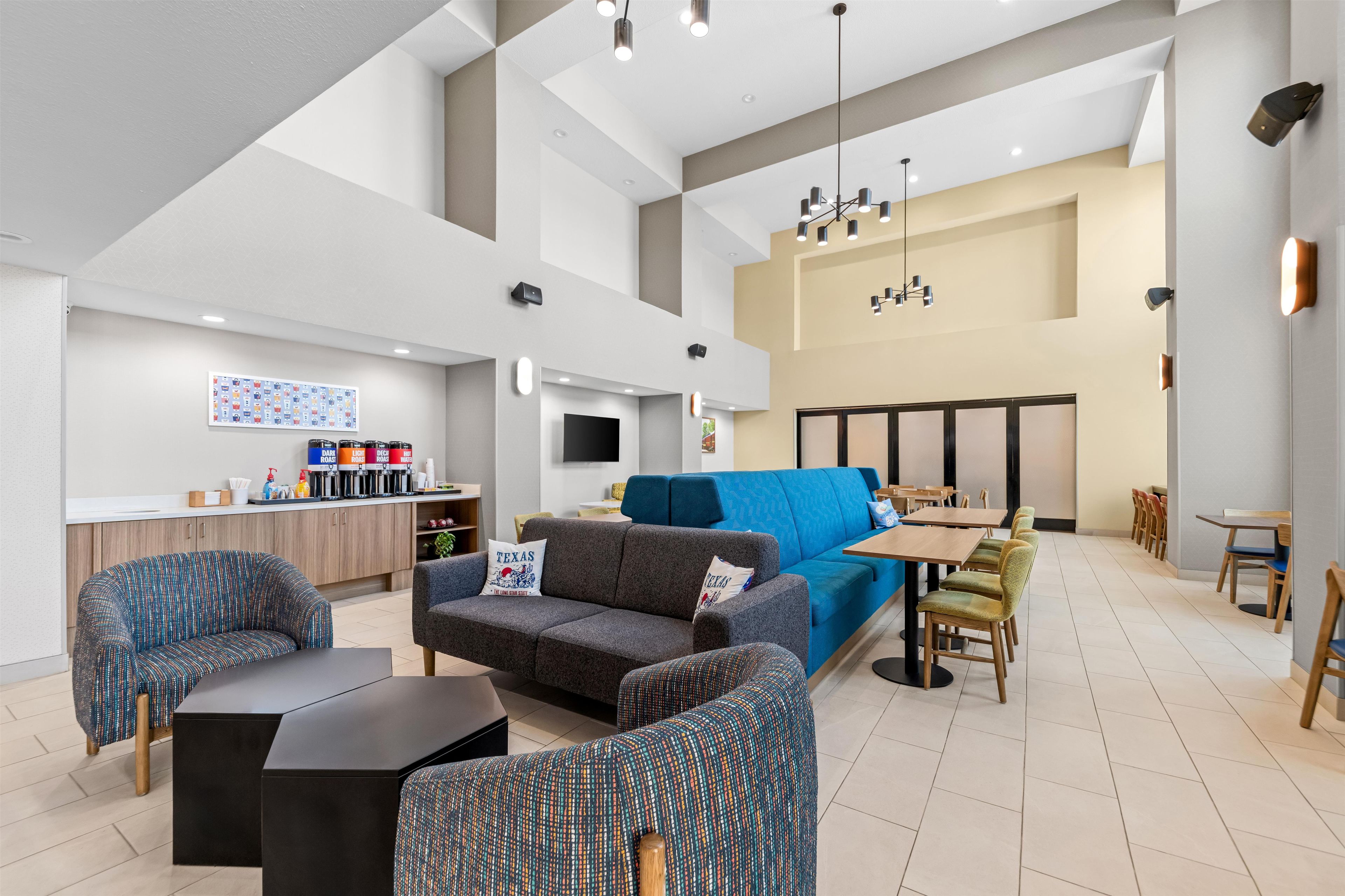 A modern interior with a seating area, a kitchenette, and a dining space.