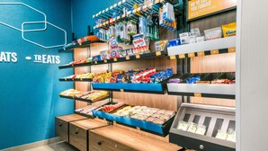 A snack display with various packaged foods and a first aid kit. - Hampton Inn and Suites Fort Worth/Forest Hill (Fort Worth)