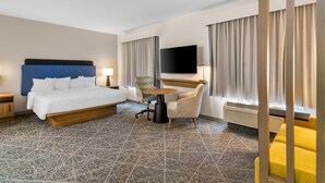 A hotel room with a bed, a desk, a chair, a TV, and a window with curtains. - Hampton Inn and Suites Fort Worth/Forest Hill (Fort Worth)