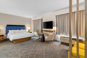 A hotel room with a bed, a desk with a flat-screen TV, a chair, and a sofa. - Hampton Inn and Suites Fort Worth/Forest Hill (Fort Worth)