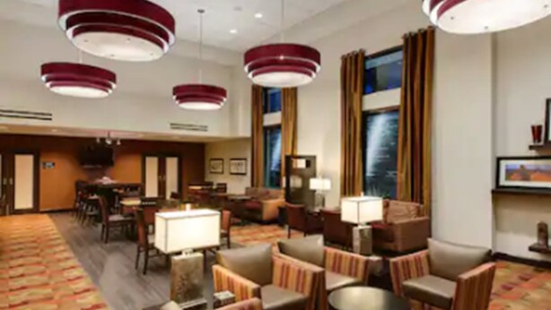 A hotel lobby with multiple seating areas, a reception desk, and large windows. - Hampton Inn & Suites Phoenix Chandler-Fashion Center AZ (Chandler)