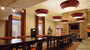A spacious conference room with a long table, multiple chairs, and modern pendant lighting. - Hampton Inn & Suites Phoenix Chandler-Fashion Center AZ (Chandler)