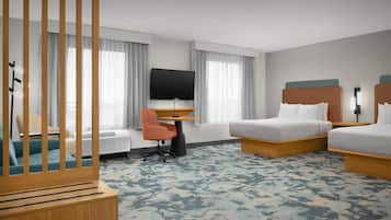 A hotel room with a bed, a desk with a TV, a chair, and a wardrobe.