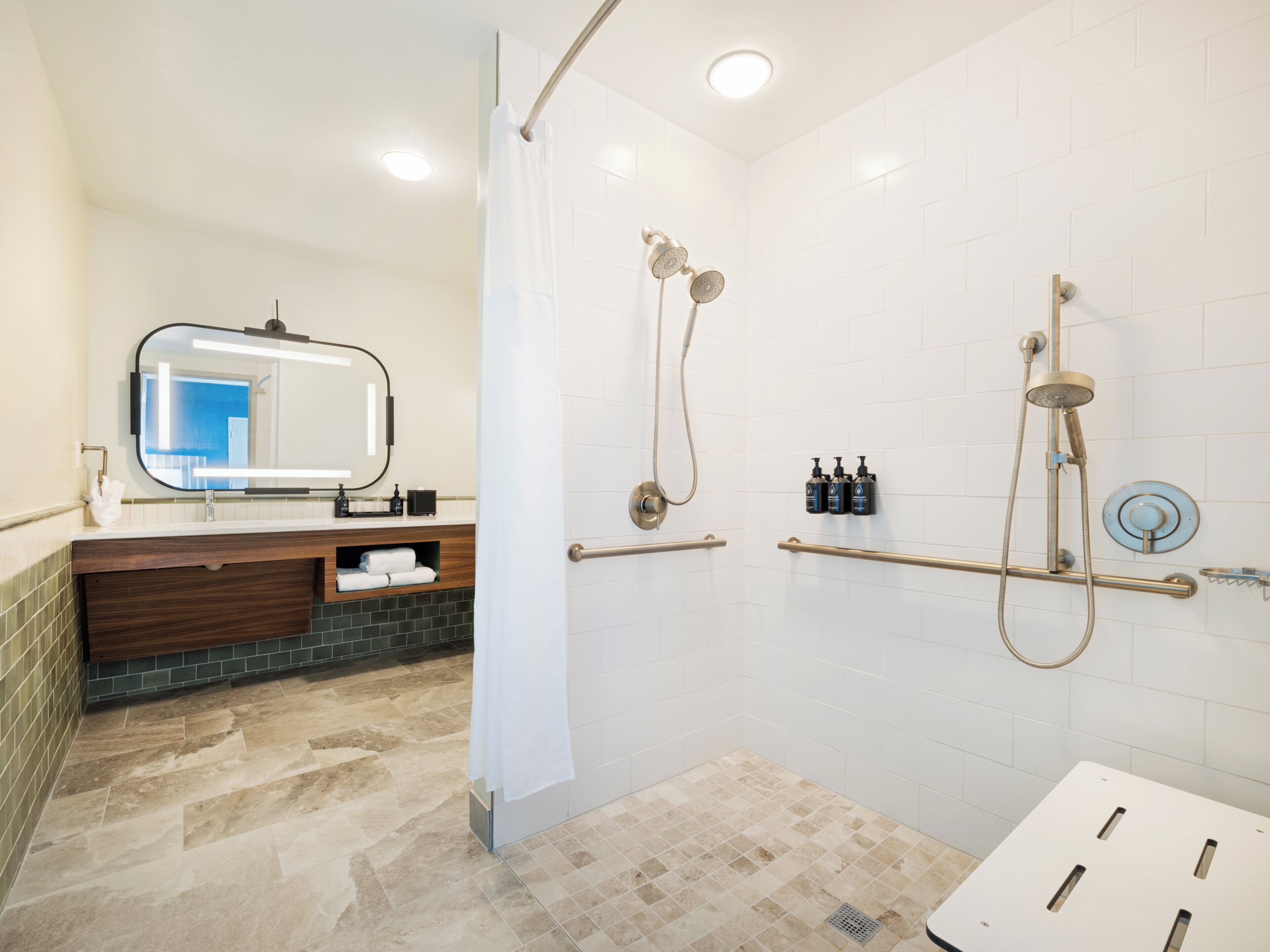 A modern bathroom with a shower, a vanity with a mirror, and a towel rack.