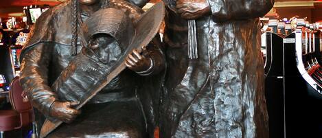 A statue of two figures in traditional attire, likely representing historical or cultural significance.