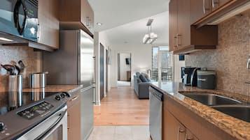 Deluxe Suite, 2 Bedrooms | Private kitchen | Fridge, microwave, stovetop, dishwasher