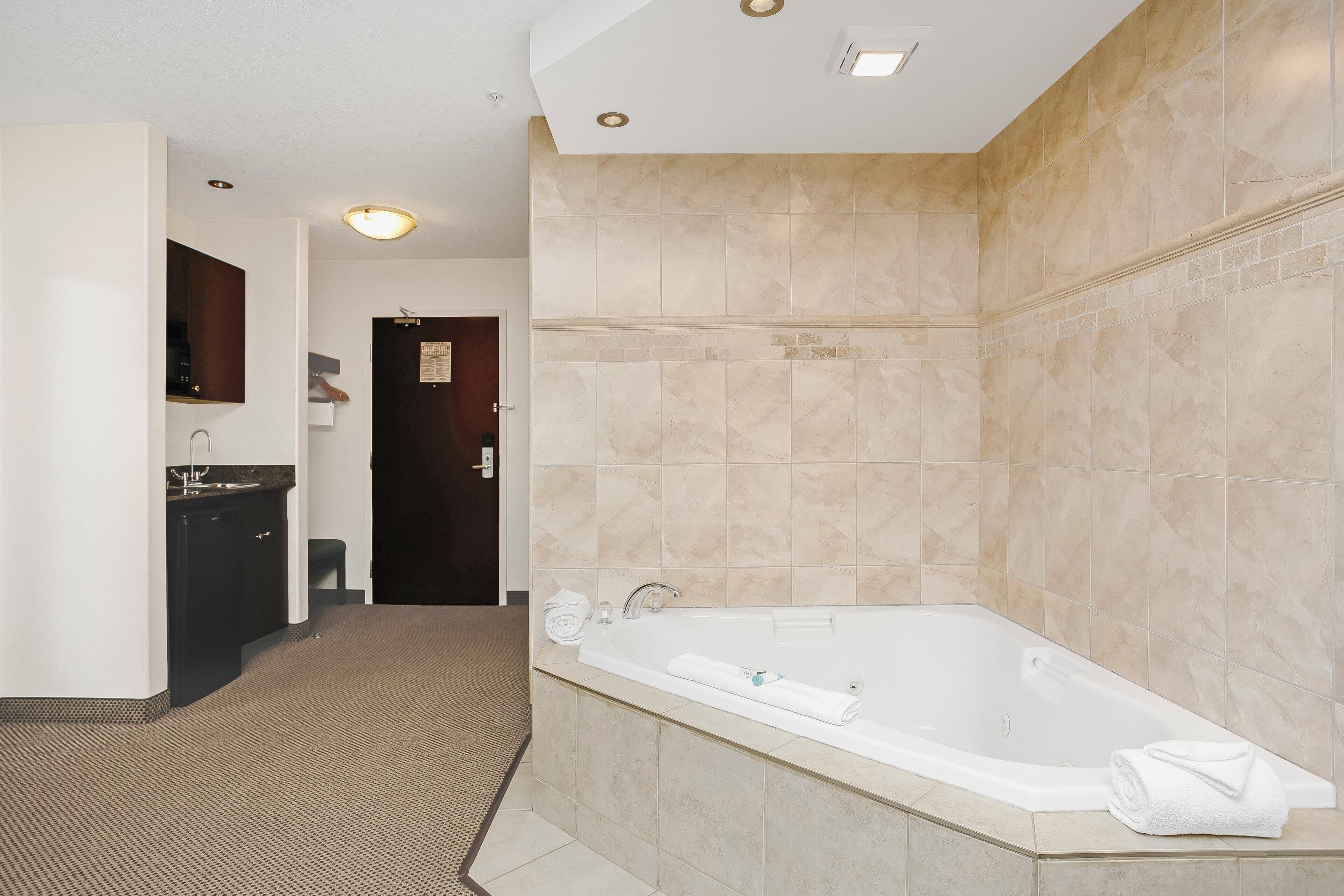 A modern bathroom with a freestanding bathtub, a sink, and a mirror.