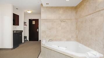 A modern bathroom with a freestanding bathtub, a sink, and a mirror.