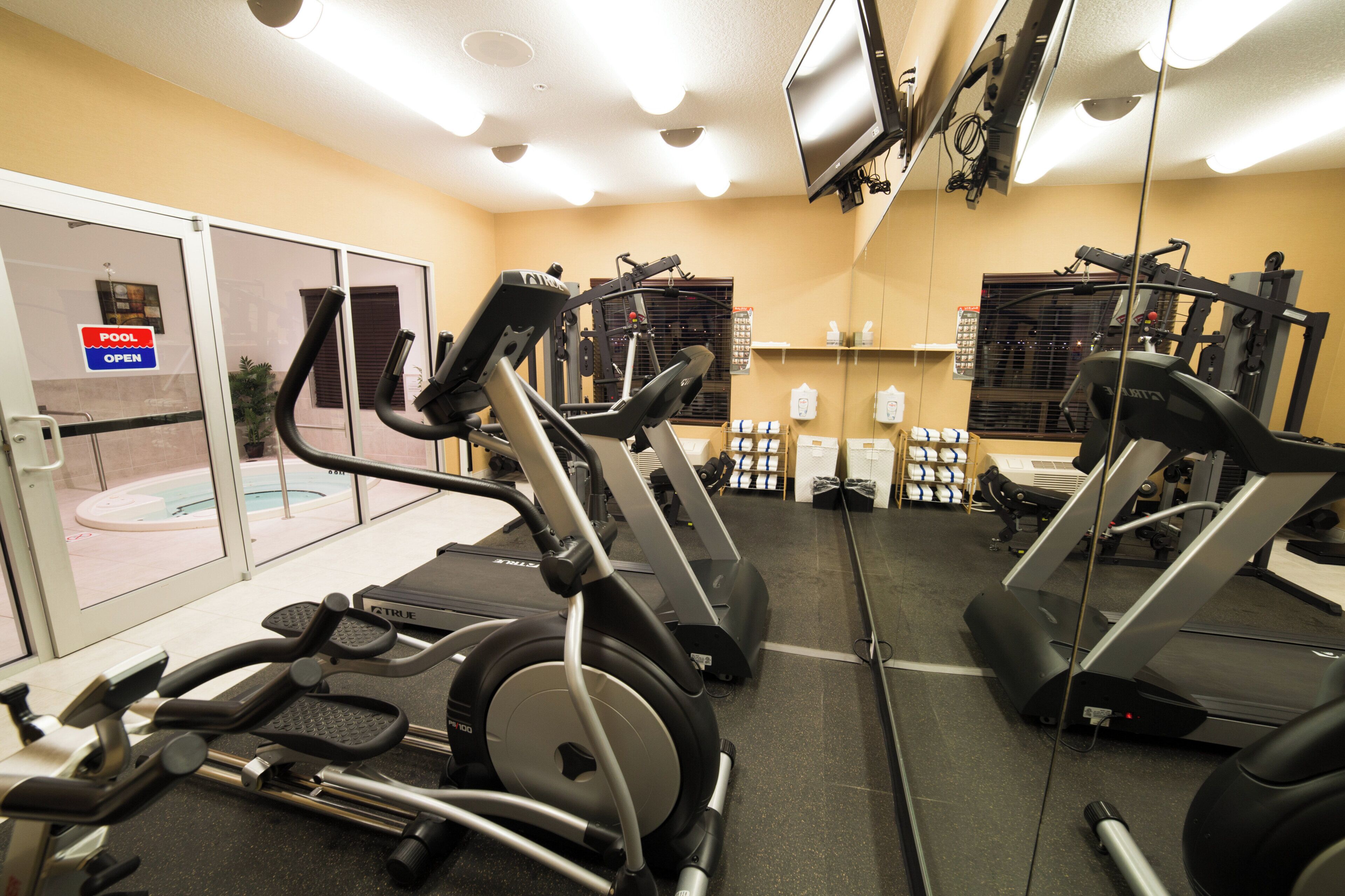 A gym with treadmills, stationary bikes, and weight machines.