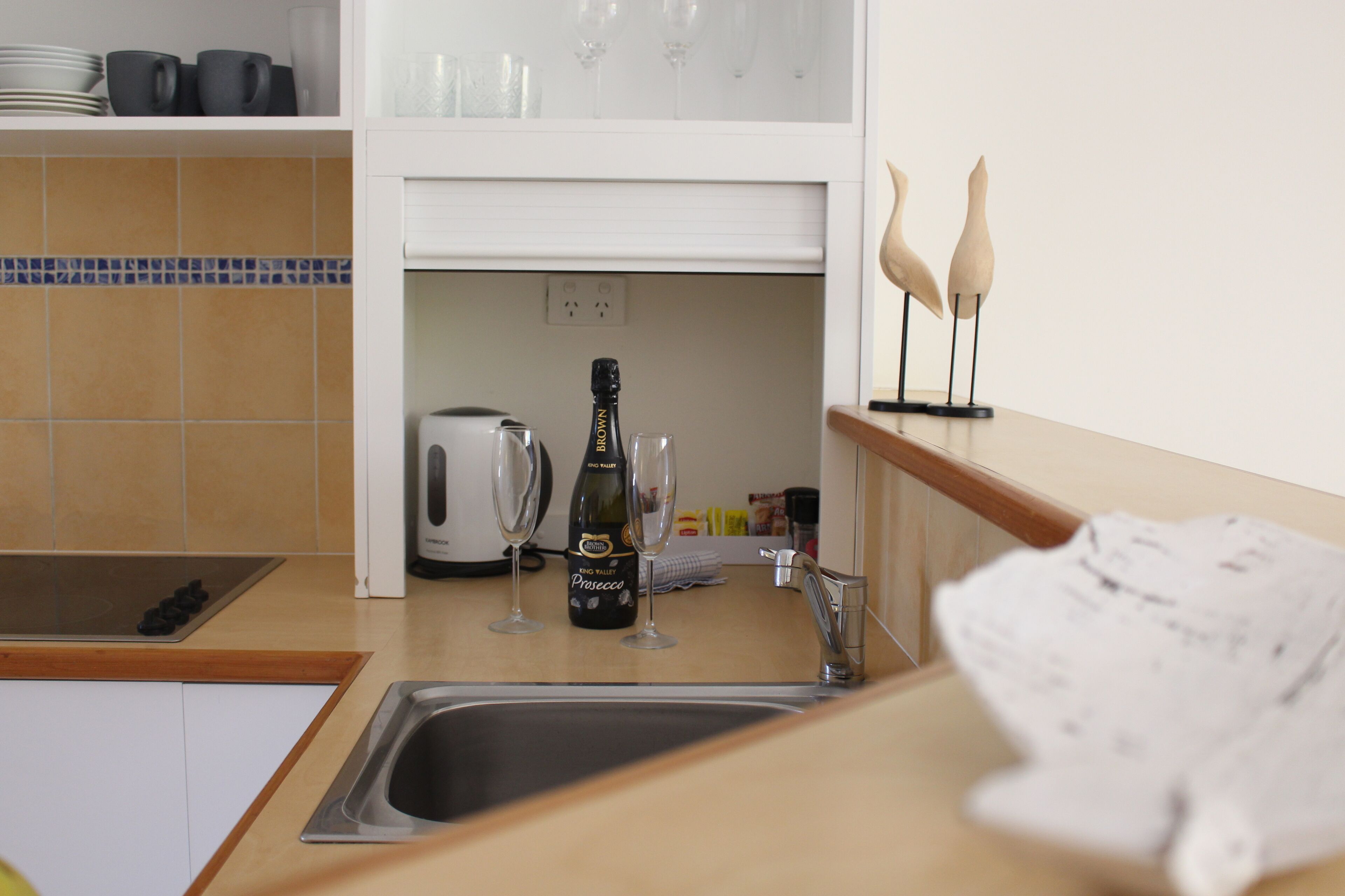 full-sized fridge, microwave, stovetop, coffee/tea maker