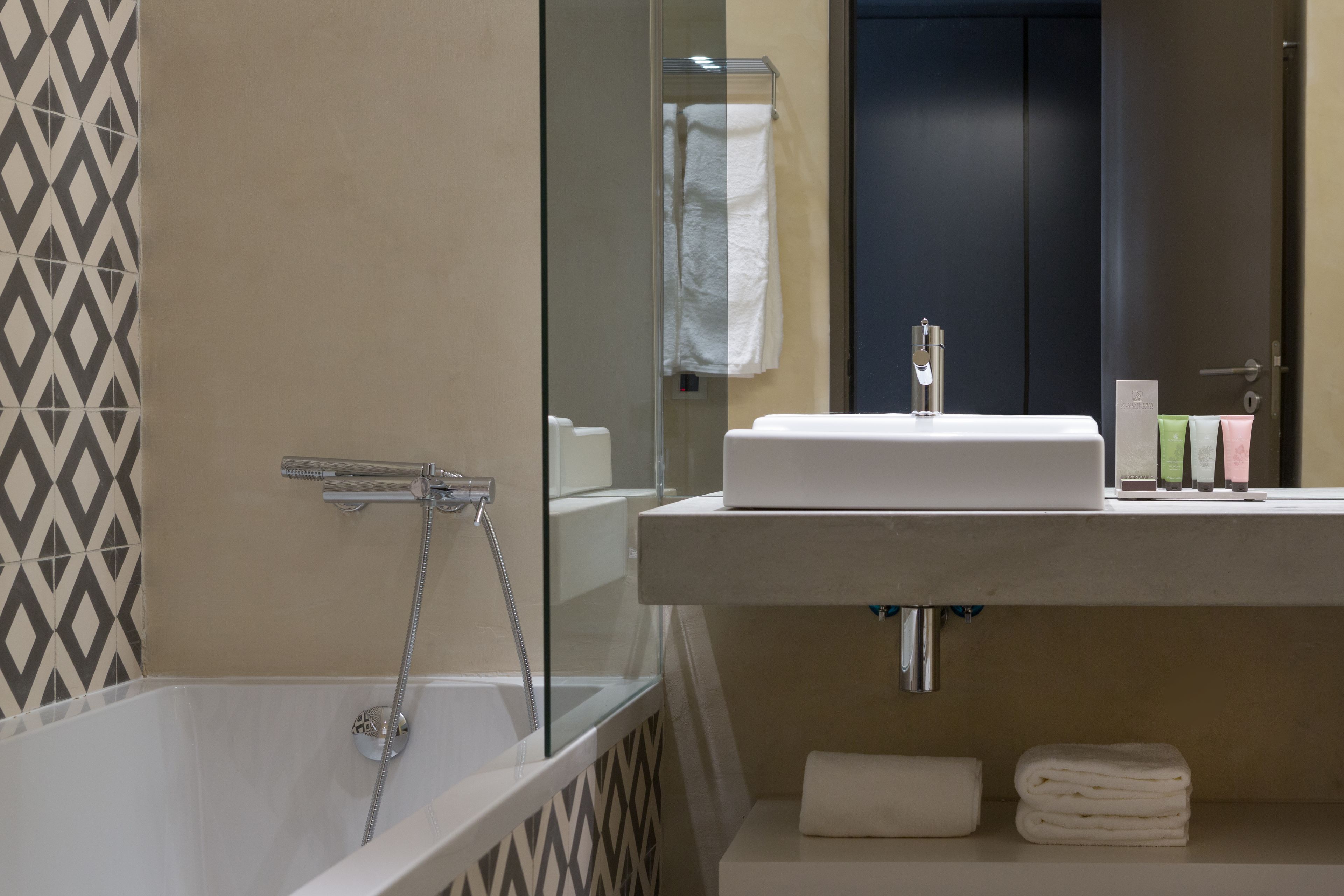 designer toiletries, hair dryer, towels