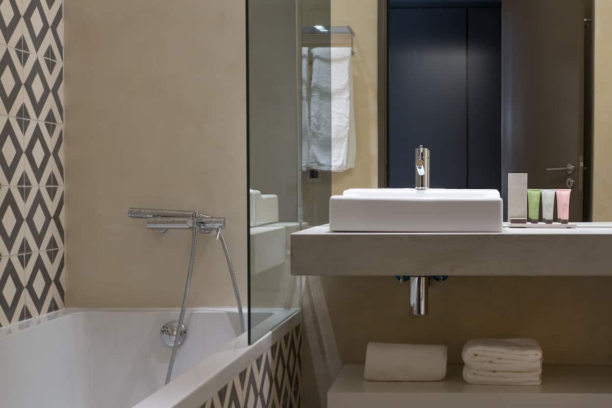 designer toiletries, hair dryer, towels