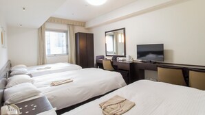 A hotel room with two beds, a desk with a computer, a TV, and a telephone. - Hearton Hotel Higashishinagawa (Tokyo)