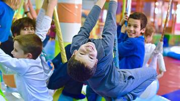 Children playing on a colorful playground structure.