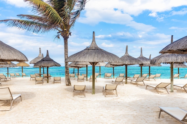 On the beach, white sand, sun loungers, beach umbrellas