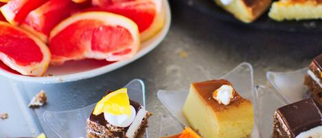 A variety of desserts including cakes and pastries, some topped with fruits and cream.